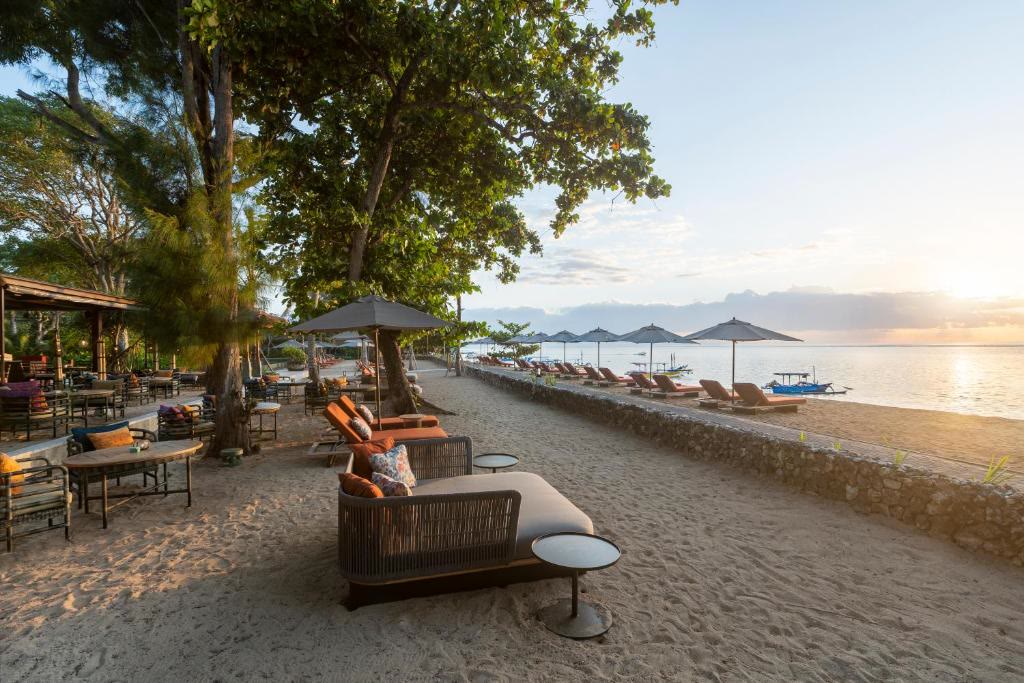 Loungers on the sand at Sanur as the sun goes down